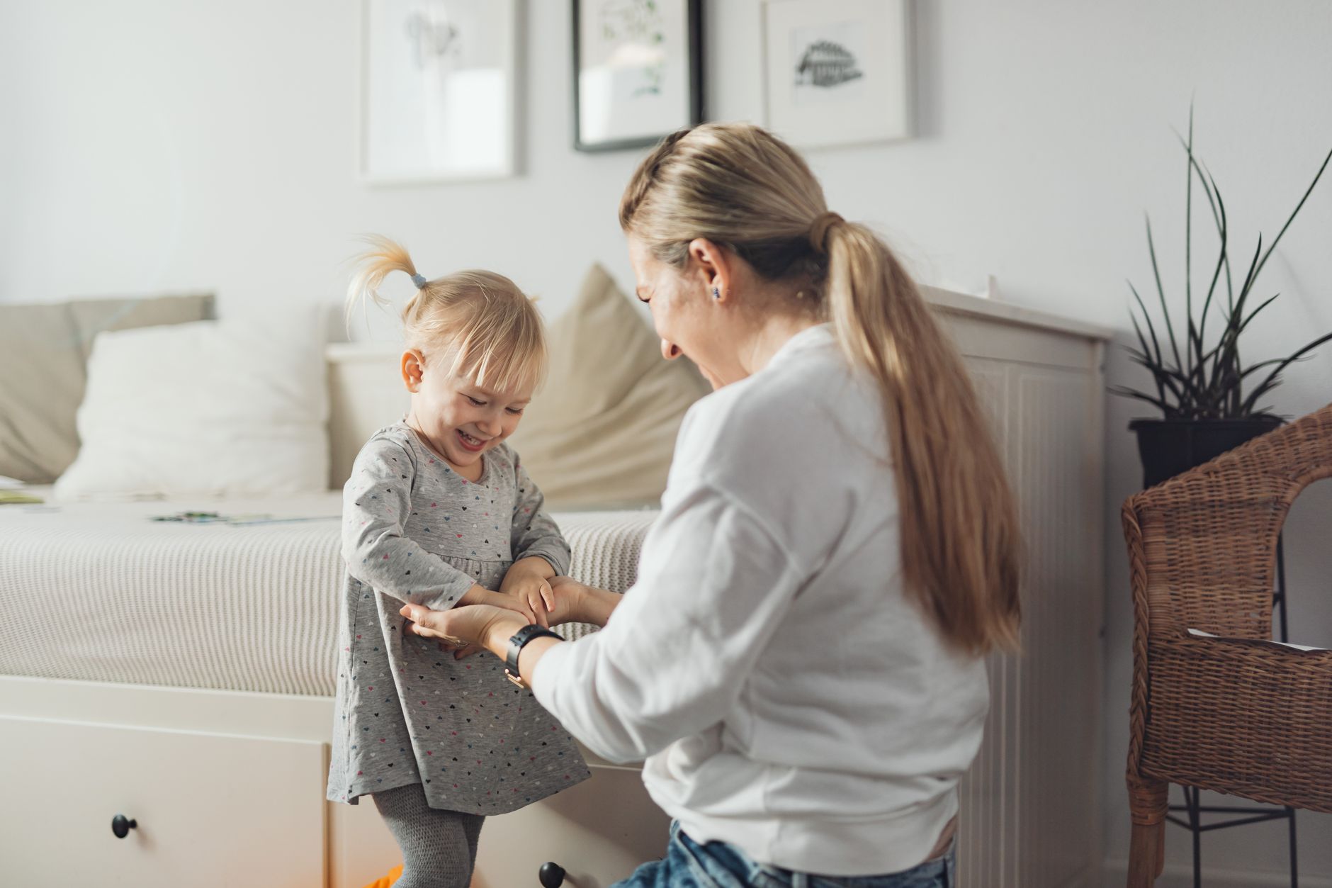 Mama i córka bawią się i śmieją w przytulnym domu